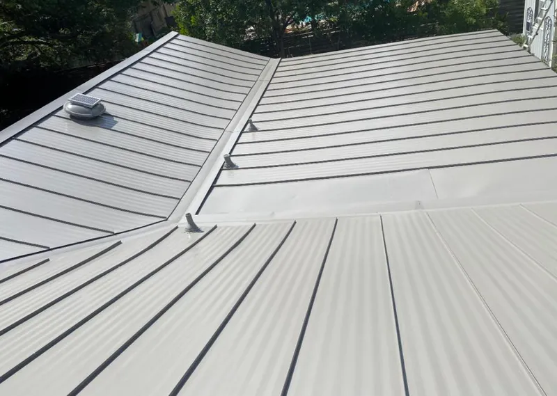 Solar attic fan installed on a metal roof for Roof Ventilation in Granbury